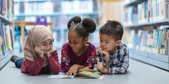 Three kindergarten students reading together