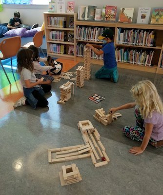 Students building with Keva Planks