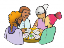 family sitting at table with papers