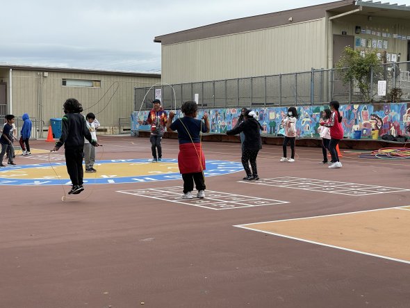 Class of students jumping rope outdoors