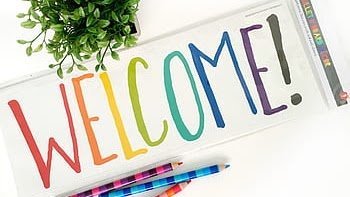 Welcome sign in rainbow letters