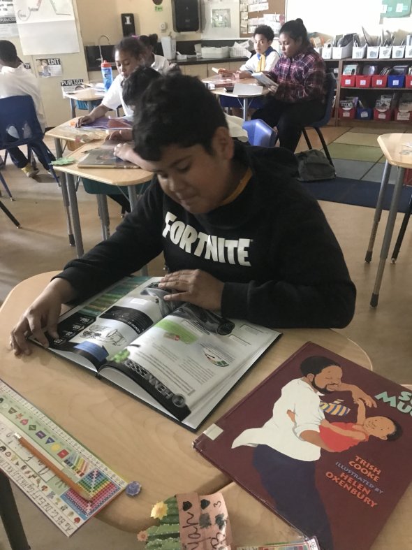 Fourth-grade student reading independently