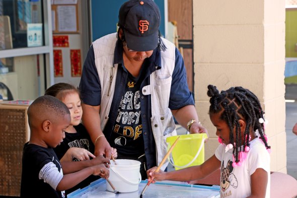 children and teacher doing activity at a table