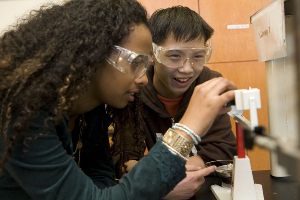 Two students working on a science project together 