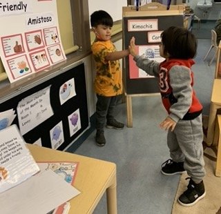 boys doing high 5 greeting