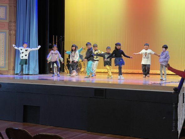 Class of second-grade students dancing on stage