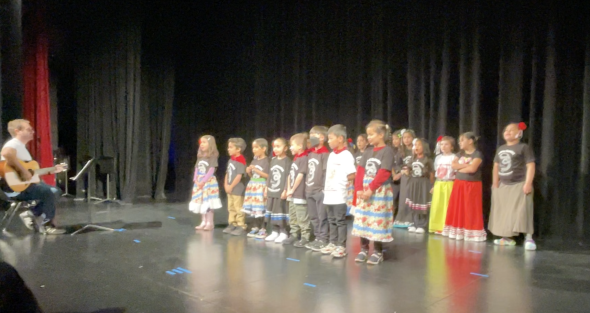 Class of 2nd grade students performing on stage