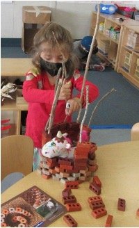 child using loose parts to build