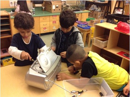 children tinkering with old cd player
