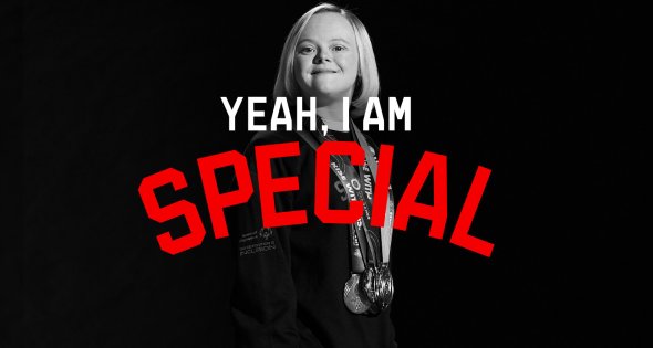 blond girl with down syndrome smiling with several medals hanging around her neck. Text reads, Yeah, I am special