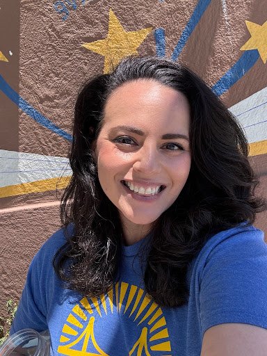 A selfie of Principal Sarah Seaton, smiling in front of a background of stars.