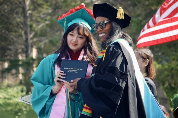 Principal gives diploma to student