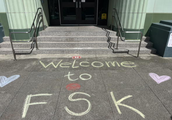 Welcome to FSK with hearts written in chalk in front of doors to school