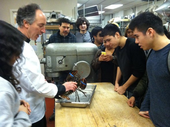 Students visit a restaurant kitchen to cook lobster.