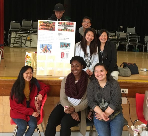 high school students with poster about soda drawbacks