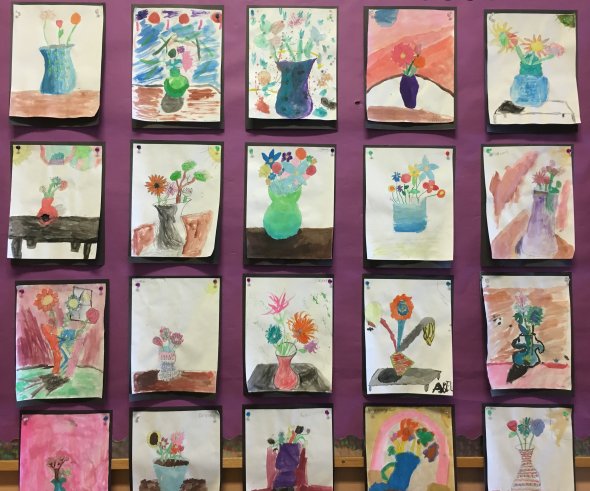 Water color pictures of flowers in vases done by students.