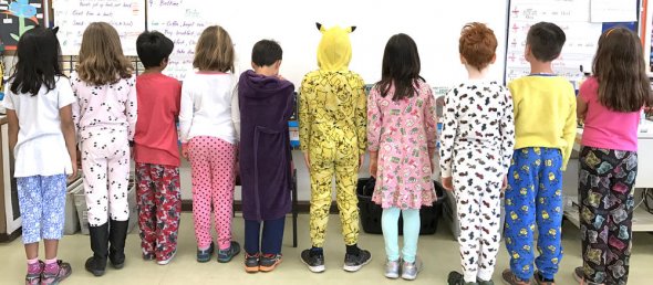 Eight students wearing pajamas