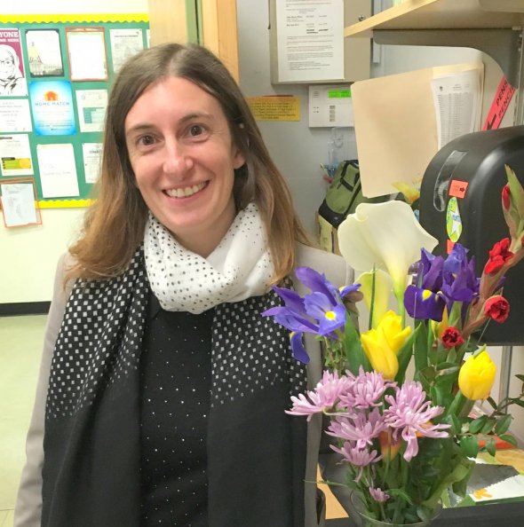 Female school employee holding flowers