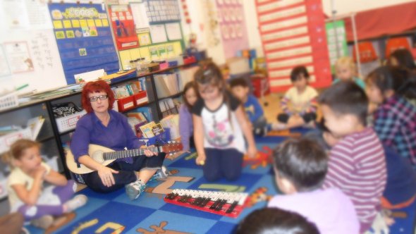 Music class with children siting on the rug