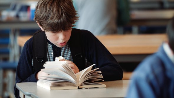 a boy reading a book