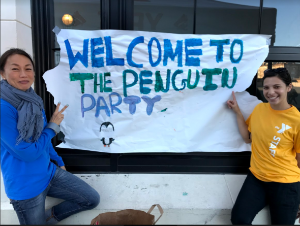 Staff at Marina Beacon Center holding a sign that says Penguin Party