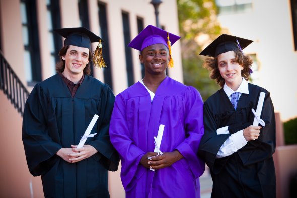 Three students with graduation gowns