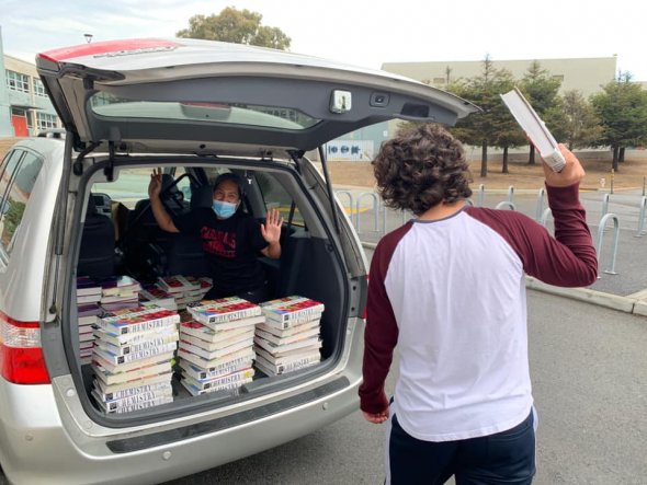 Parent volunteers moving text books