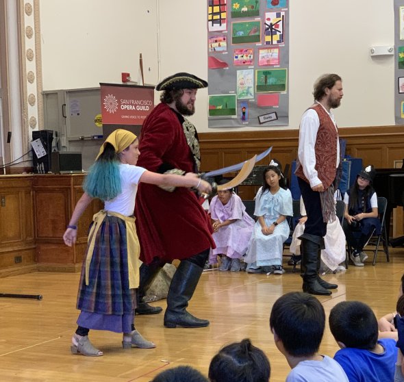 one student with two opera actors dressed as pirates