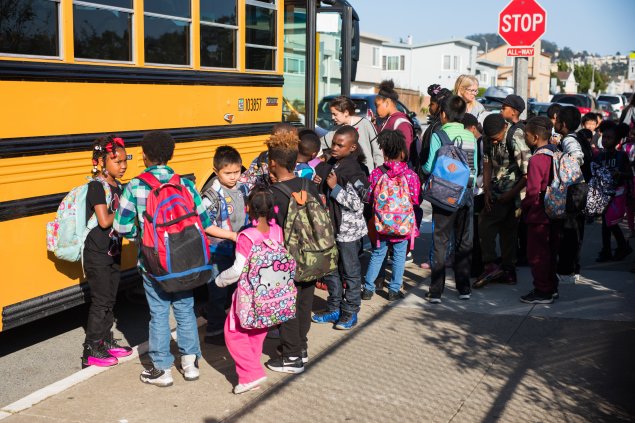 Students in line to board a school bus