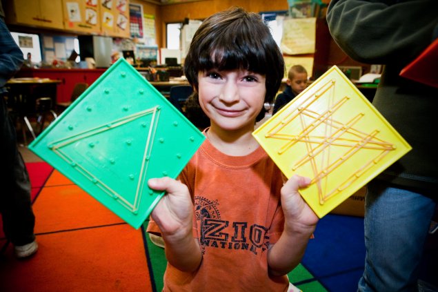 Elementary school student with shapes made with rubber bands