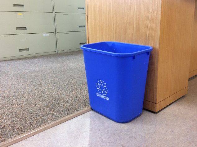 Blue recycling bin in office