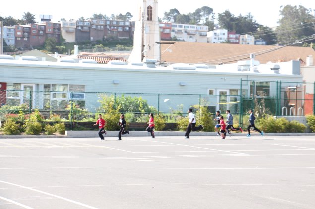 Middle school students running in PE 