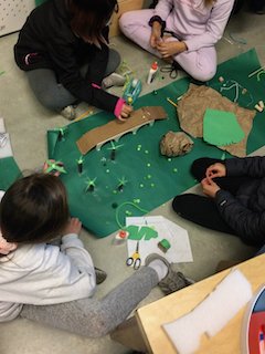 Students build a model bridge together