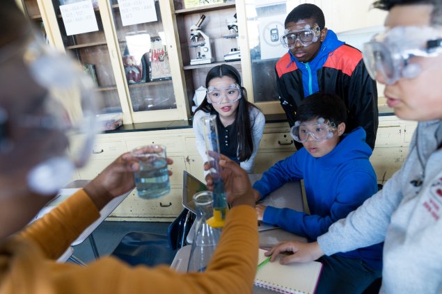 Students observing lab equipment