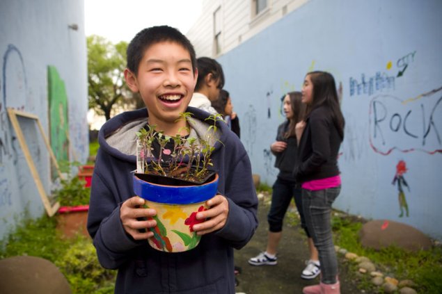 Student holding garden pot