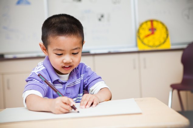 Young student writing in notebook