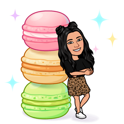 Bitmoji leaning against a tower of macarons