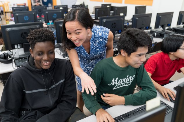 Teacher and students at a computer