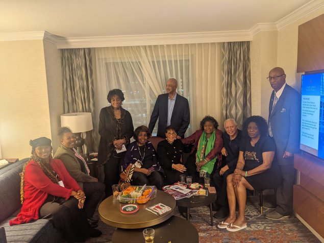 Educators in arch smiling for the camera