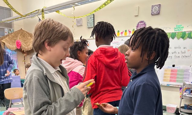 Two 4th-grade students engaged in discussion