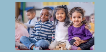Image of children sitting down smiling 