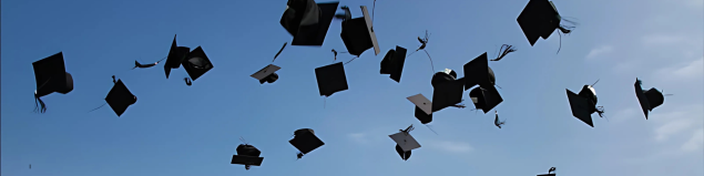 Graduation caps thrown in the air