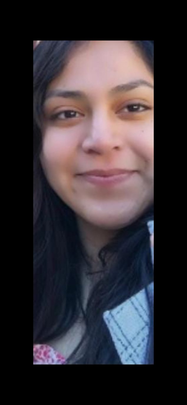 Smiling Latina woman with long brown hair