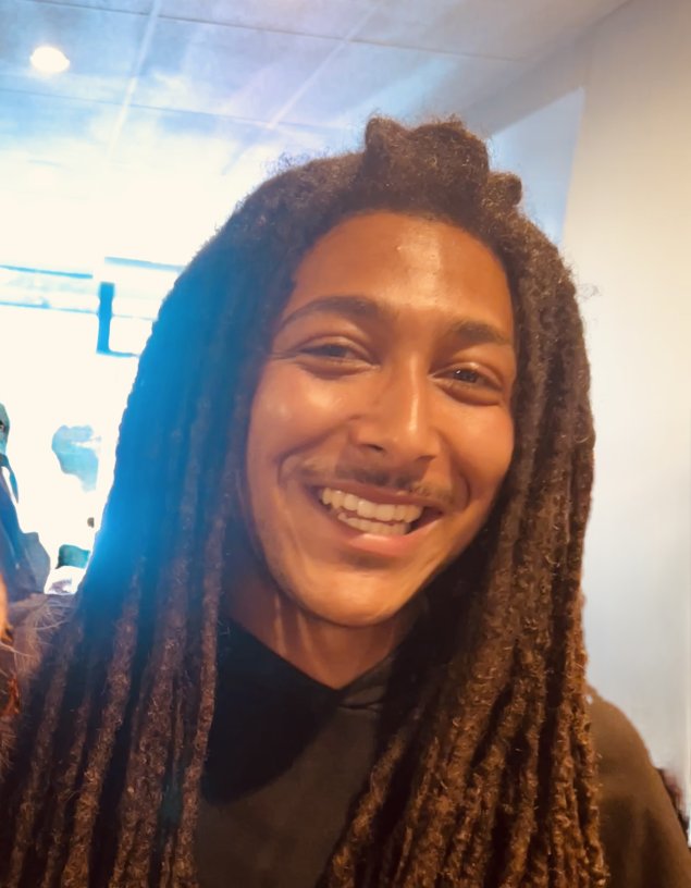 Smiling biracial man with dreads