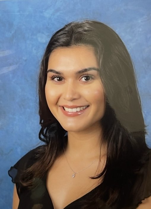 Smiling Latina woman with long brown hair