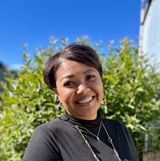 smiling multiracial woman with hair pulled back