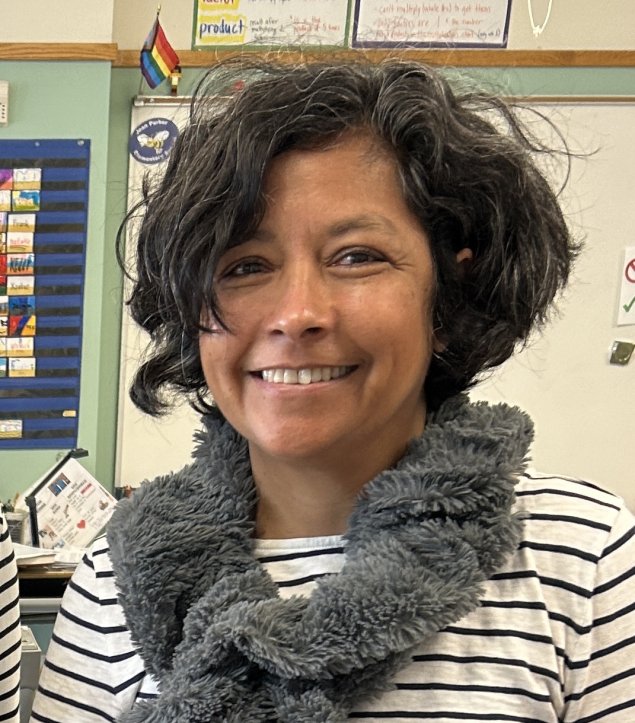 Smiling Latina woman with short curly hair