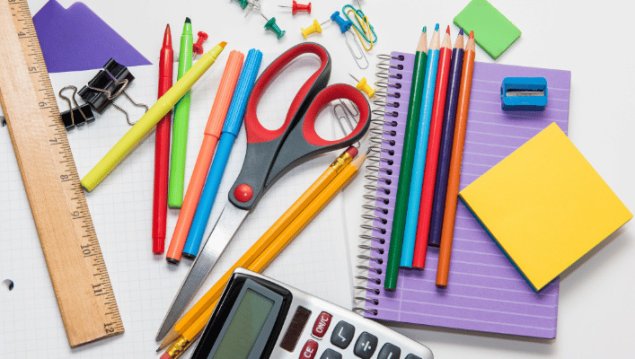 Classroom school supplies on a table.