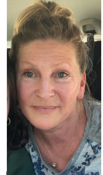 Picture of the Wellness Coordinator, a lady with dirty blonde hair, blue/ green eyes, who is smiling at the camera