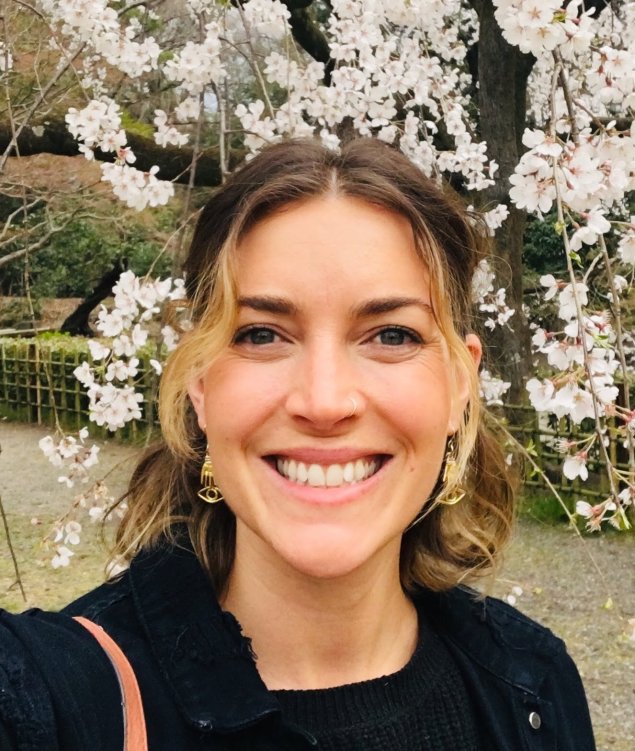 Smiling white woman with pulled back blonde hair